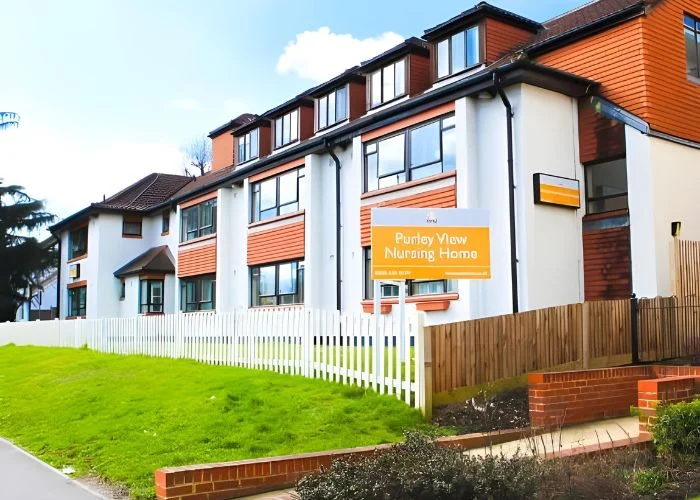 Exterior of Purley View Nursing Home with its orange sign and white fence